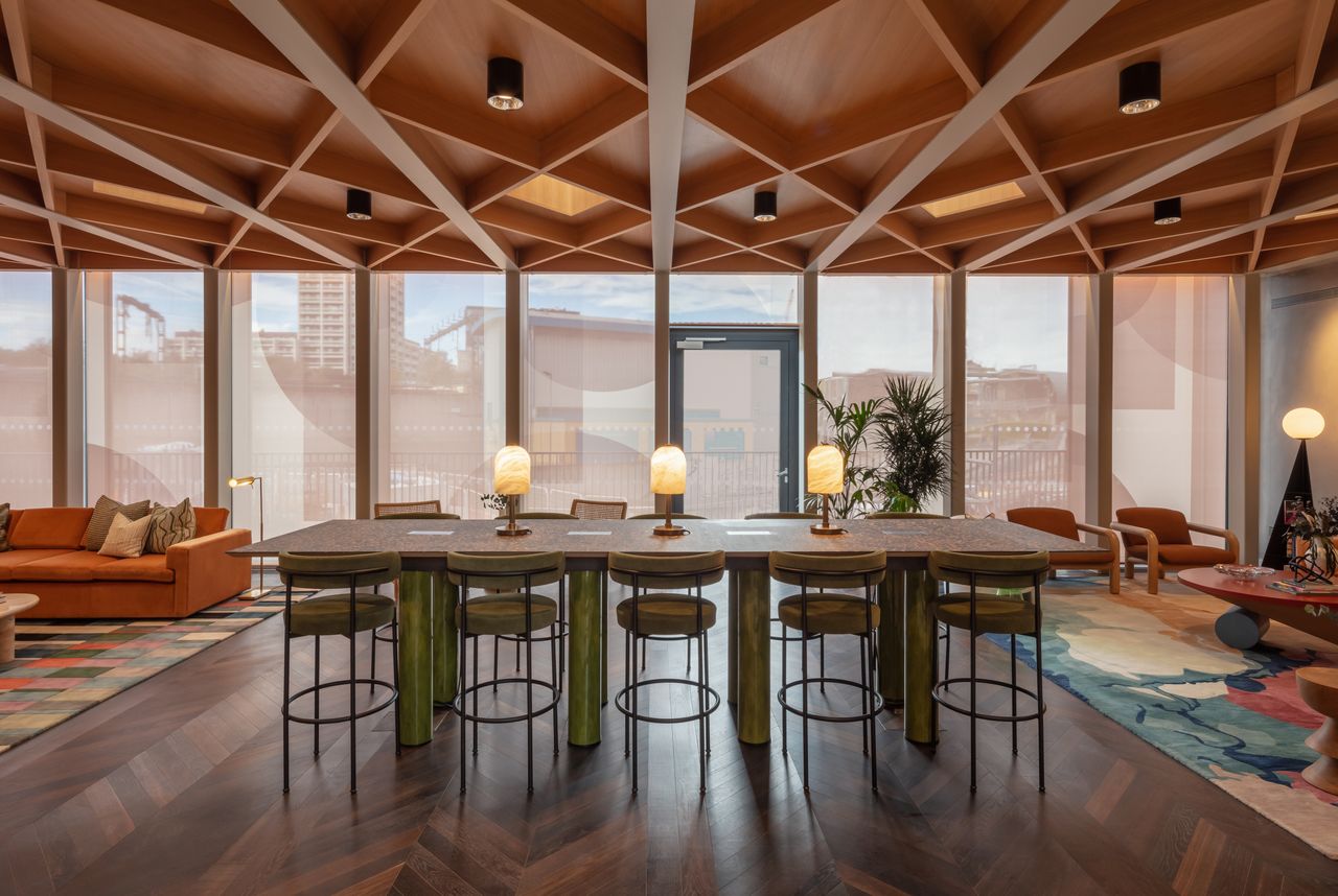 Conran and Partners_Author_Courtyard Lounge with breakfast bar type table and long views out and timber ceiling