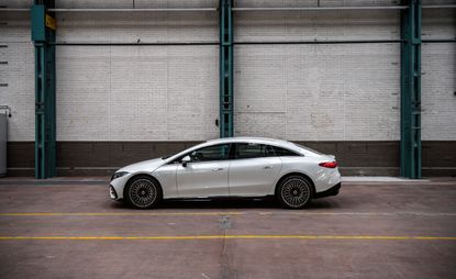 A sideways on photo of the white Mercedes EQS