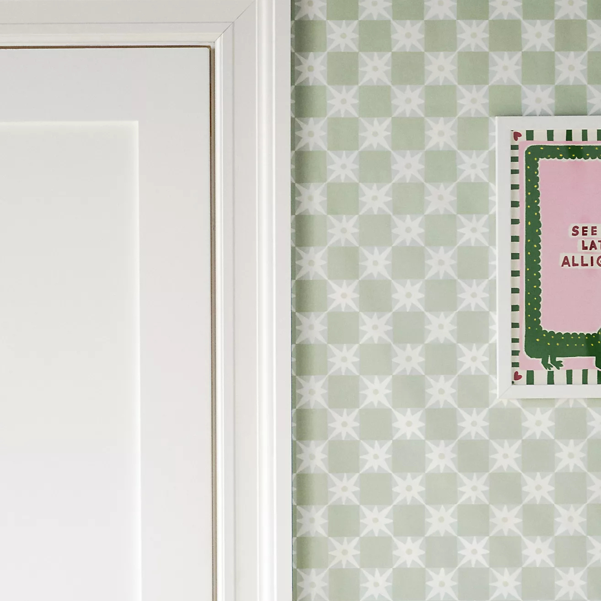 A room decorated with white and sage green checkered wallpaper