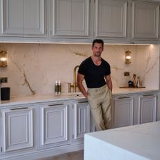 David Gandy leaning against kitchen cabinets