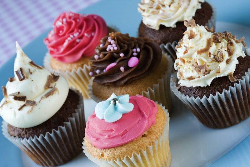 Five cupcakes on a plate. 