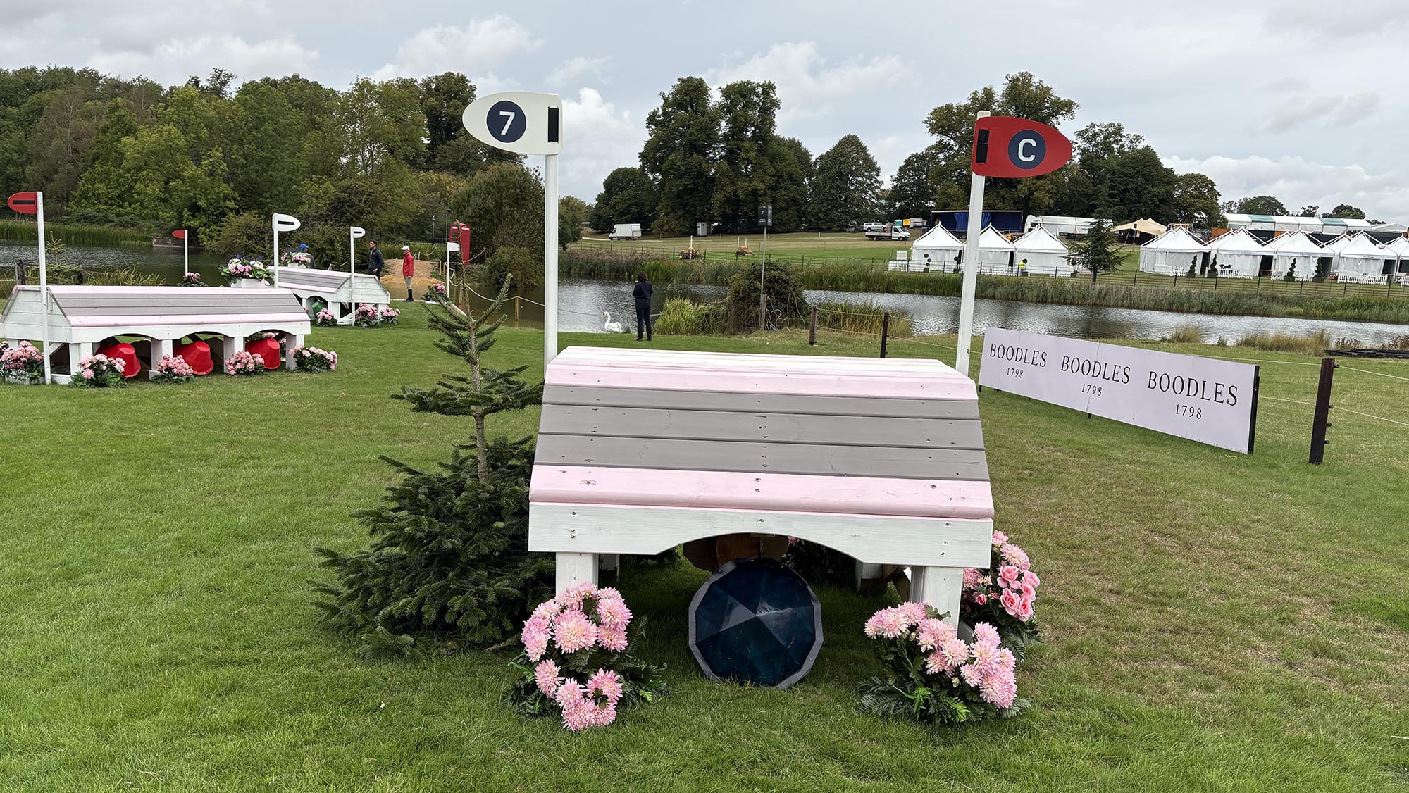 Narrow pink, grey and white fence on the Burghley cross-country course 2026