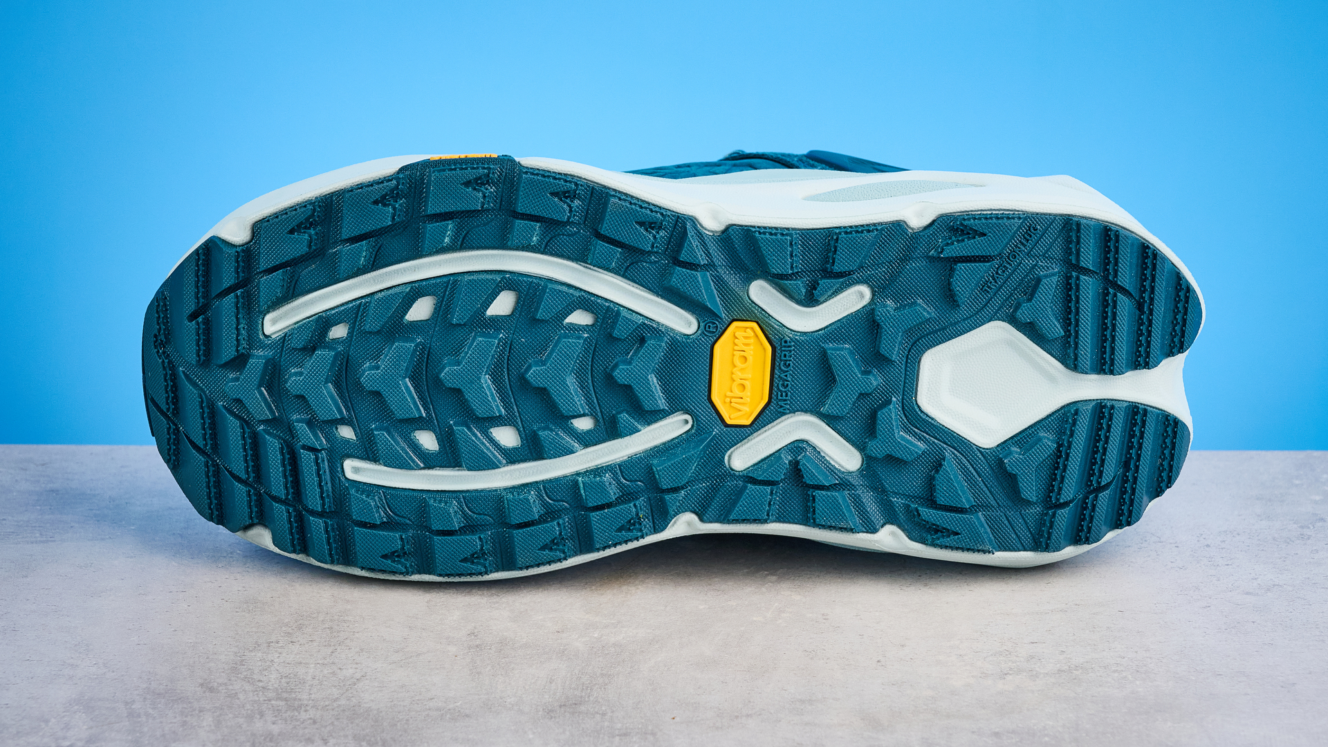 Hoka Kaha 3 Low GTX in droplet colorway photographed in front of a blue background