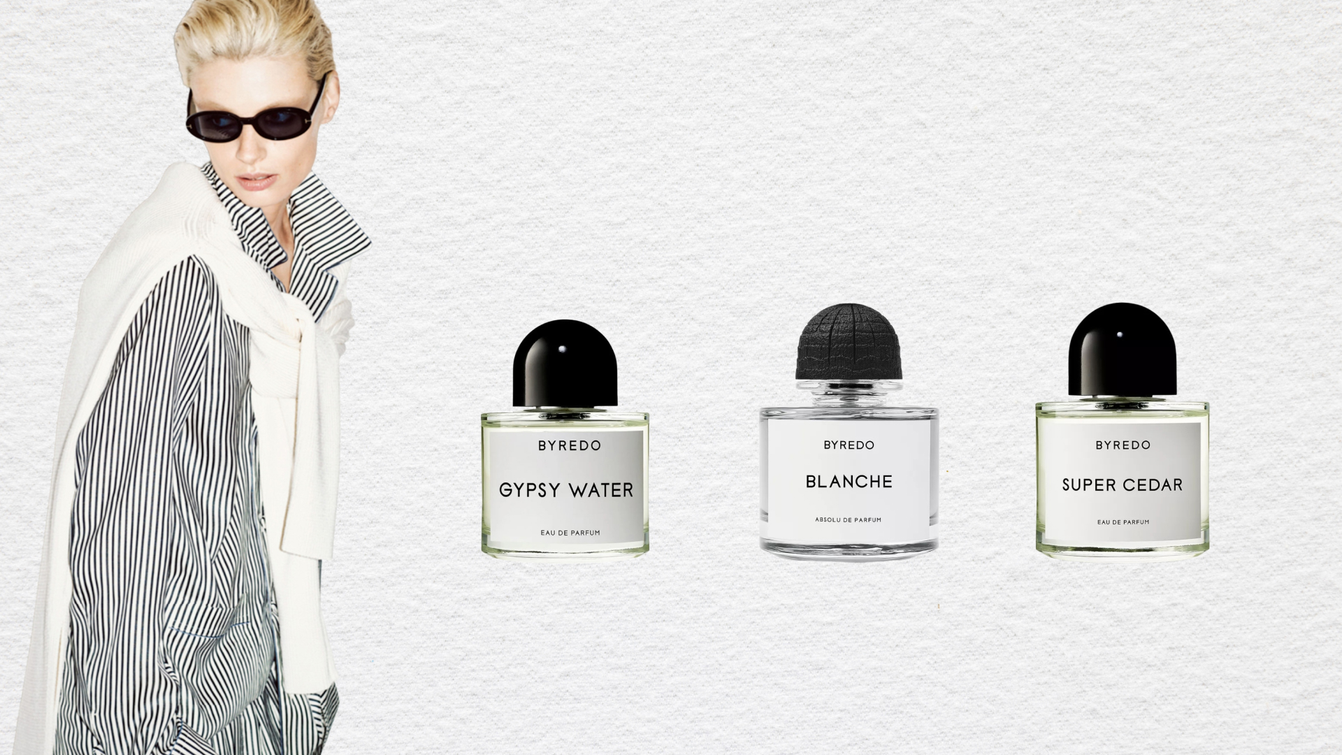 Byredo black friday cyber monday perfume sale header. A woman with blonde hair looking over her right shoulder wearing sunglasses and a black and white pinstriped set. She has a white sweater tied over her shoulders. Three byredo perfume bottles are beside her. 