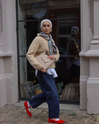 Amira in beige jumper and jeans