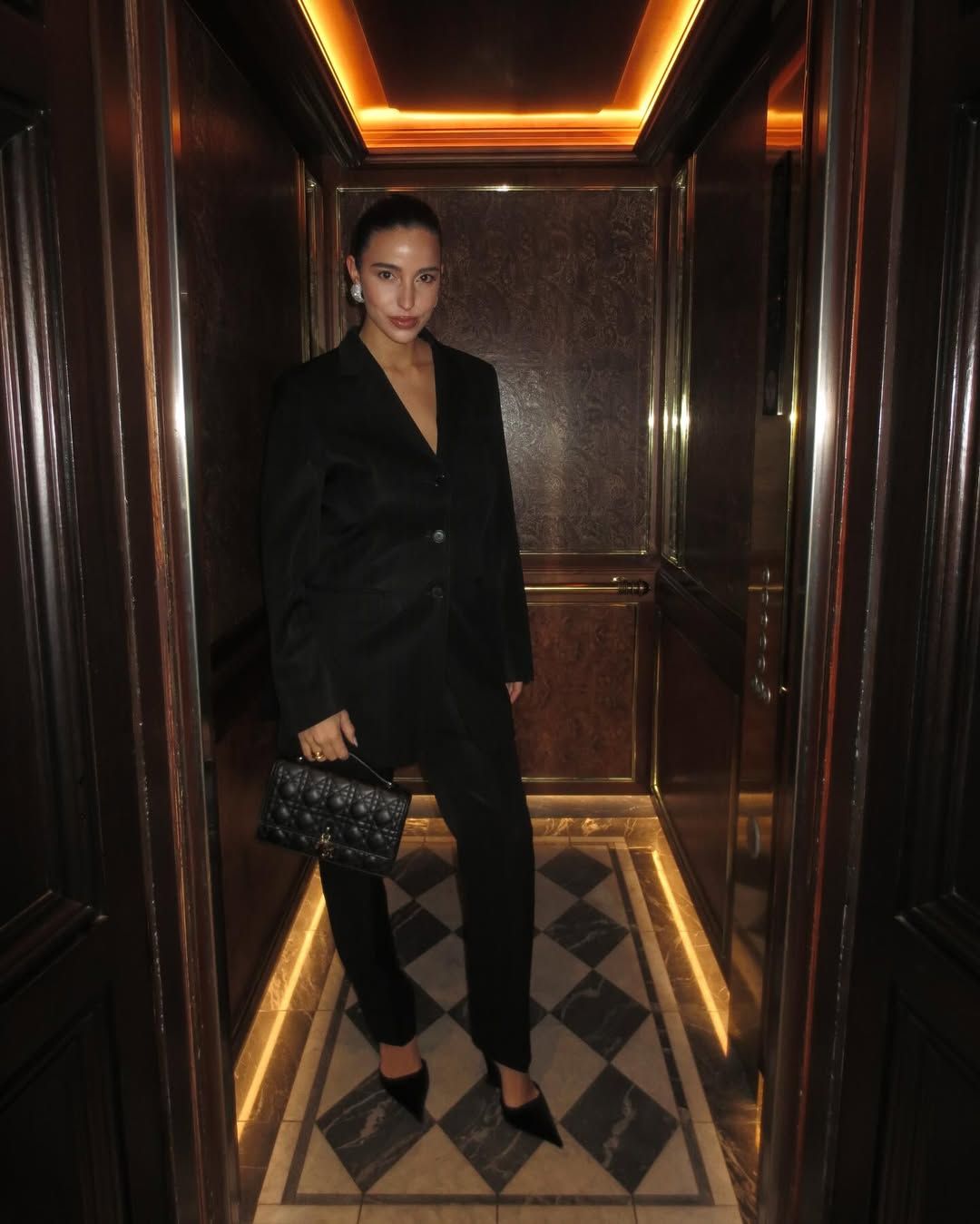 @bettinalooney wearing a black suit