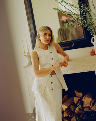 Lucy Williams in white linen vest and skirt