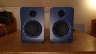 Kanto Ren speakers in blue, within a hi-fi listening room