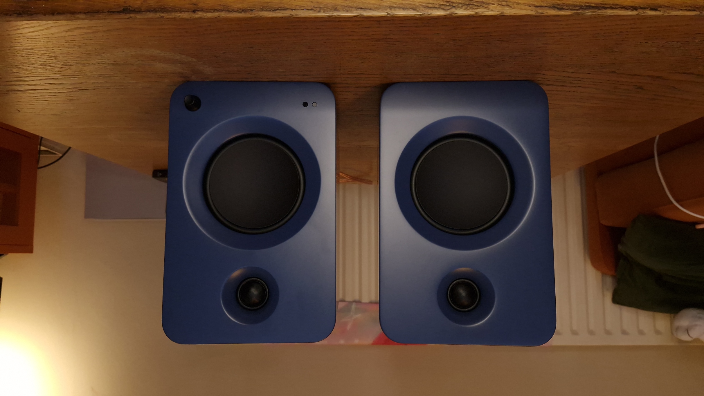 Kanto Ren speakers in blue, within a hi-fi listening room