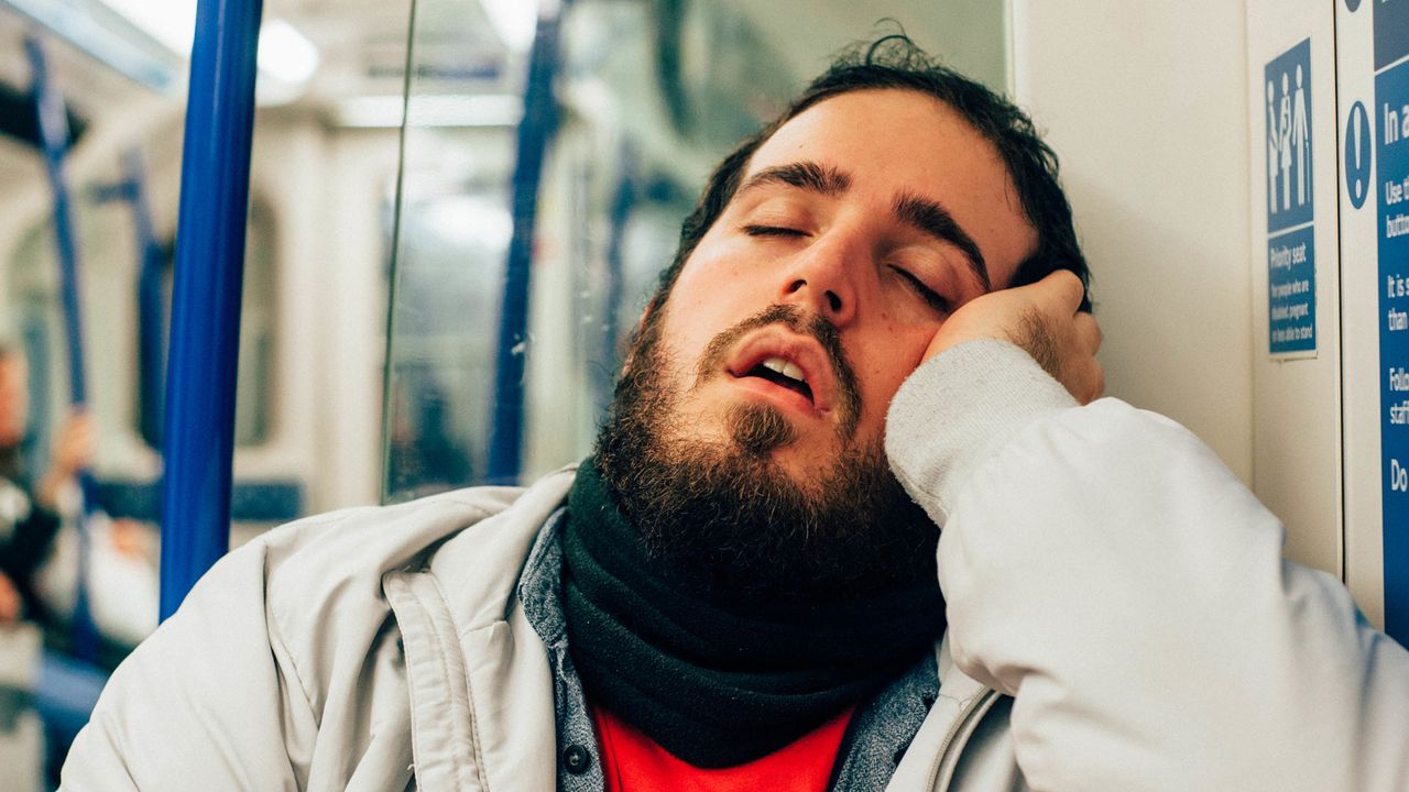 A man sleeping on the tube