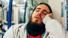 A man sleeping on the tube