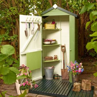 Protek potting shed painted in Pond Green and decking tiles painted in Jungle Green