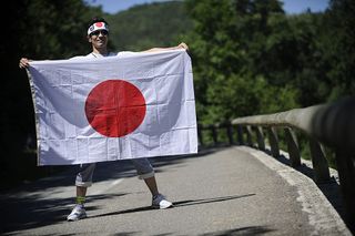 A fan holds the Japanese flag