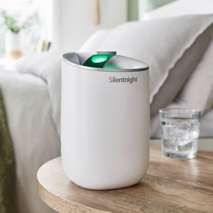 The Silentnight dehumidifier sat on a bedside table next to a glass of water