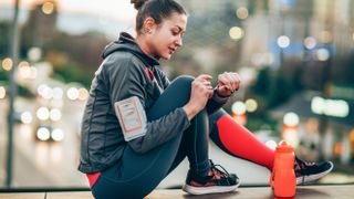 Woman checking sports watch before run