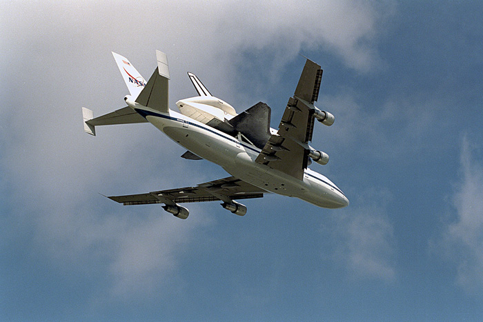 The Space Shuttle orbiter Endeavour flies atop NASA&#039;s Boeing 747 Shuttle carrier Aircraft as it returns on March 7, 1997 from a lengthy maintenance period.