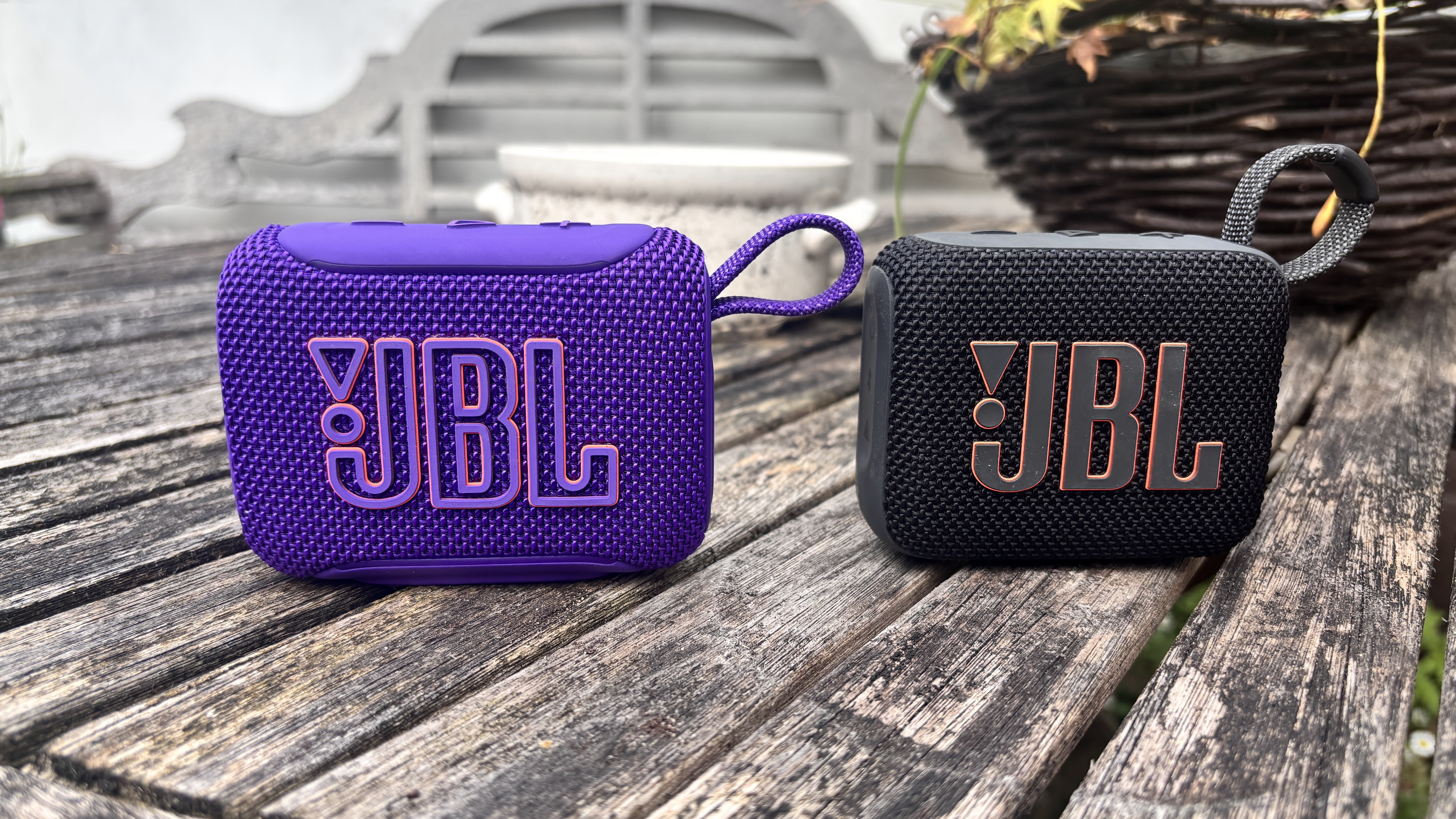 JBL Go 5 in purple on the left, next to JBL Go 4 in black on the right
