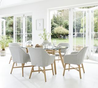 sunroom with white floor tiles and dining table