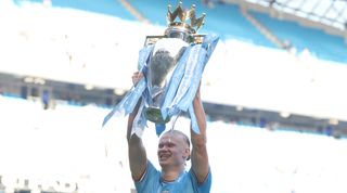 MANCHESTER, ENGLAND - MAY 21: Erling Haaland of Manchester City celebrates with the trophy after the Premier League match between Manchester City and Chelsea FC at Etihad Stadium on May 21, 2023 in Manchester, England. (Photo by Catherine Ivill/Getty Images)