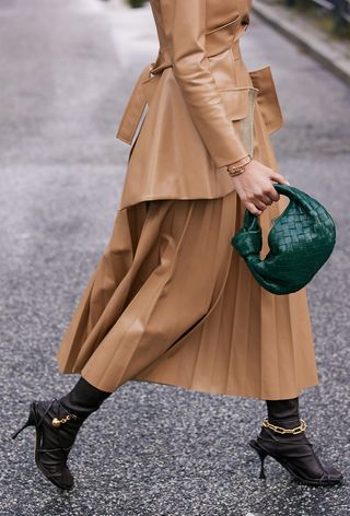 a photo of a woman wearing the italian bag brand Bottega Veneta