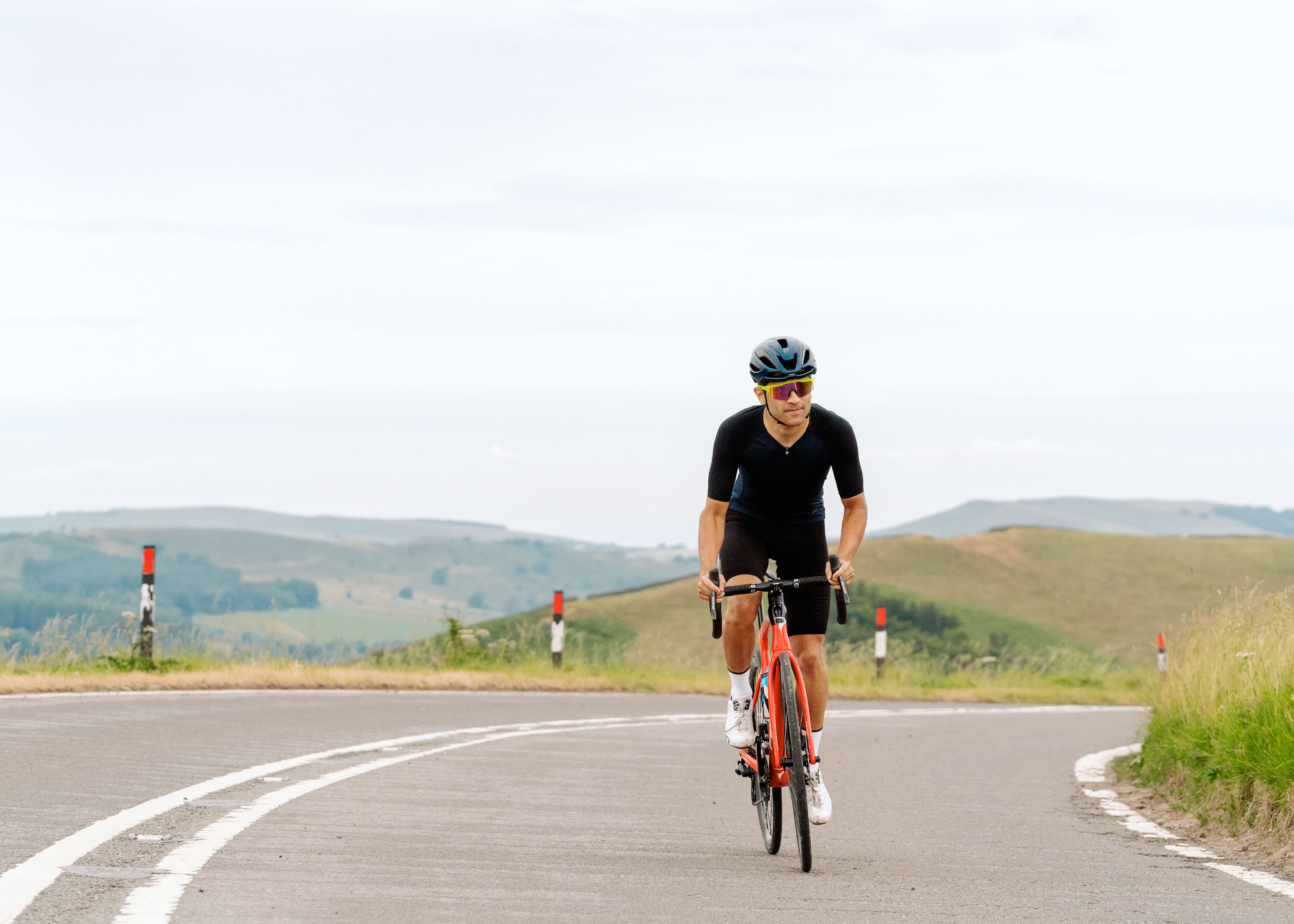 A male cyclist riding a Pinarello X in the Peak District UK