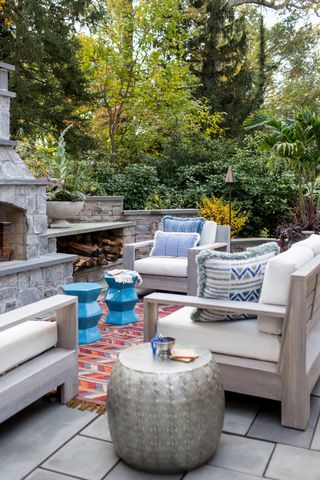 A backyard with pop colored cushions