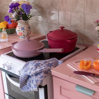 pink kitchen with hob with pans