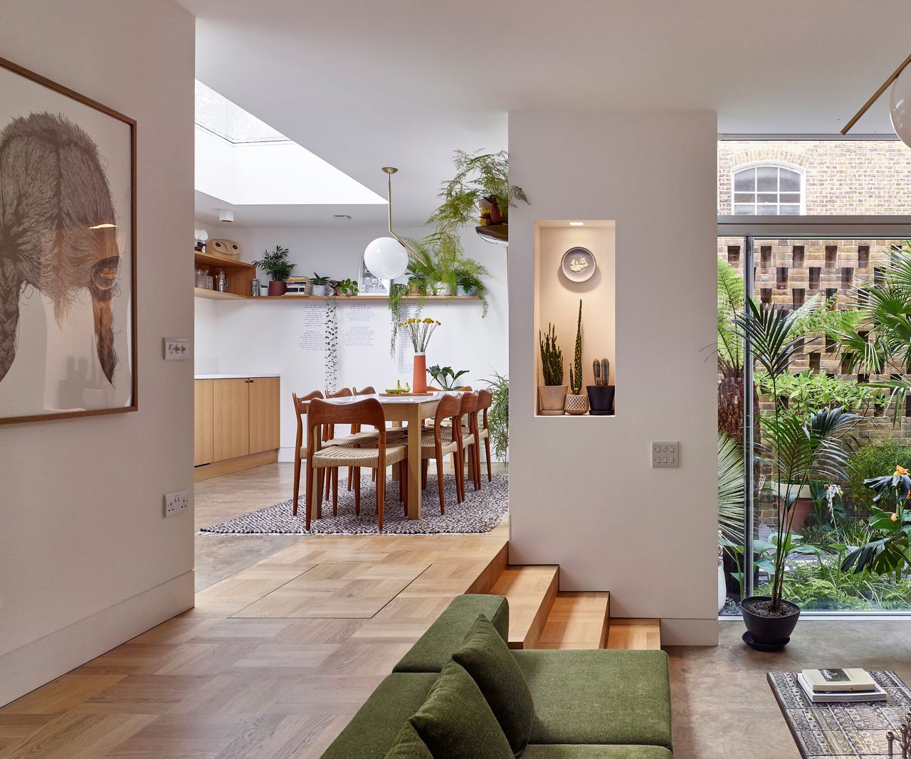 garage conversion on residential street with brick facade and a light and airy interior with split level living and kitchen diner space