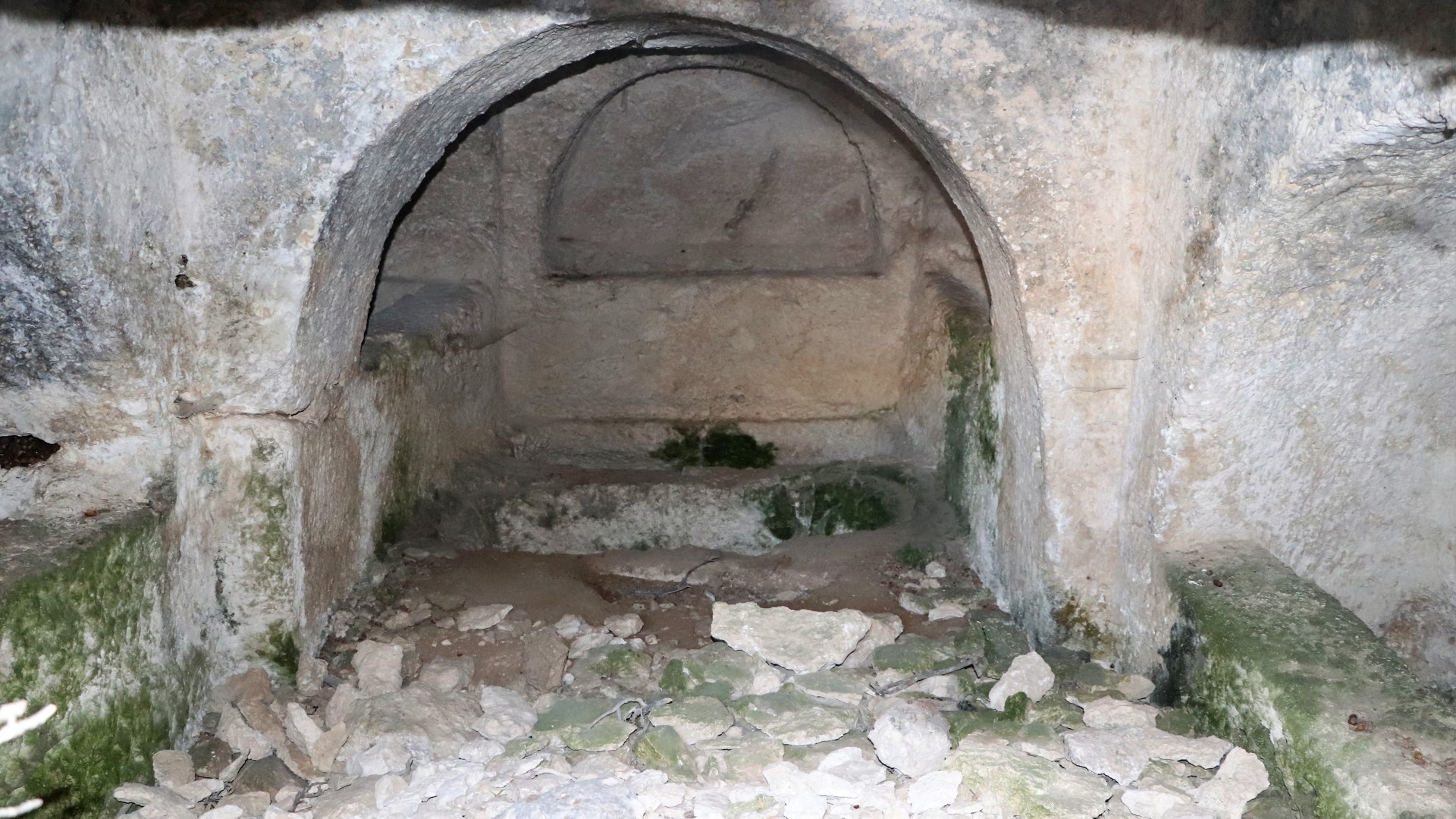 One of the rock-cut chamber tombs, with the sarcophagus carved into the floor.