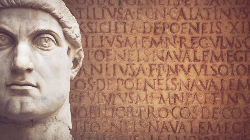 marble statue of roman emperor constantine&#039;s face on background of roman writing