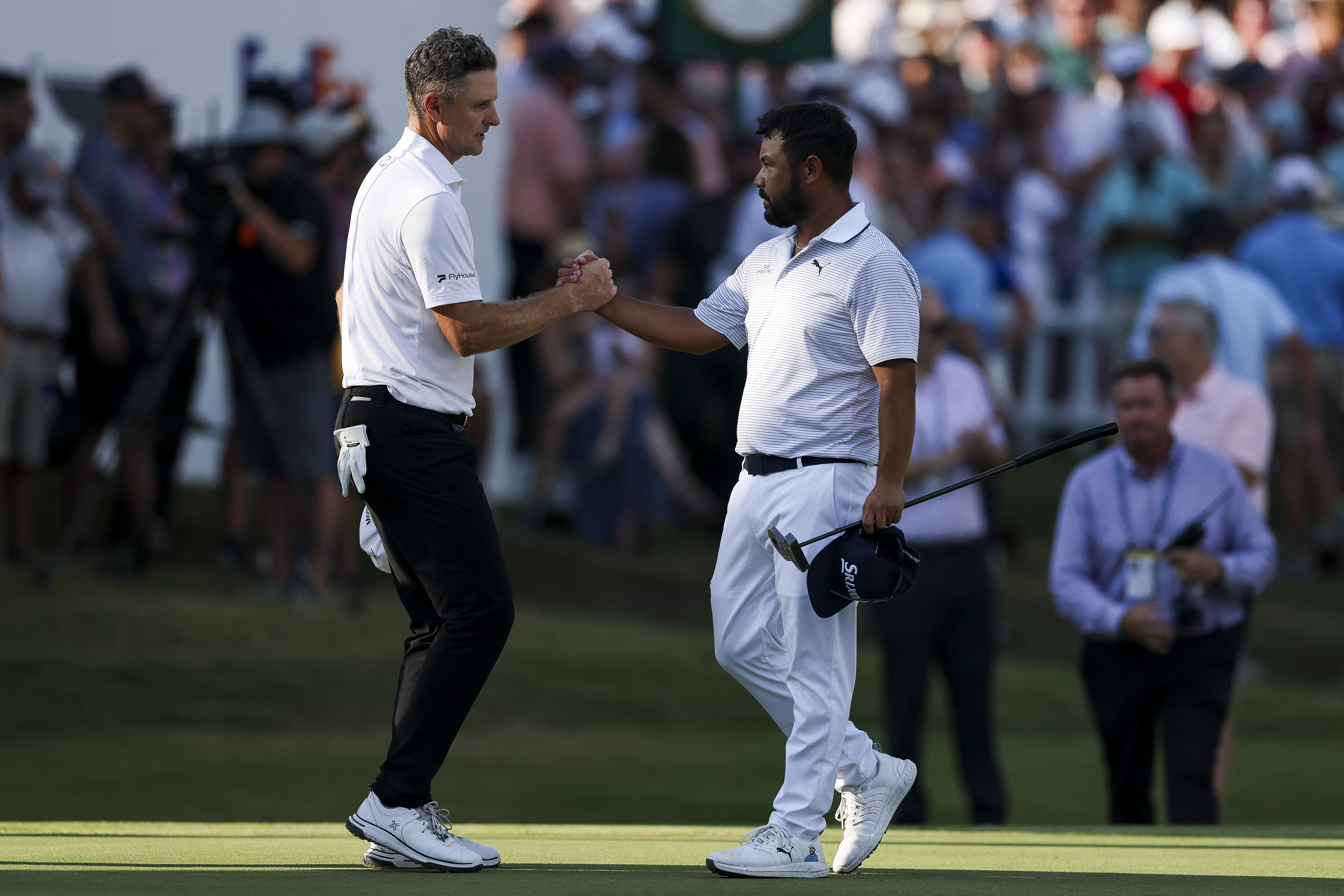 Justin Rose and JJ Spaun shake hands