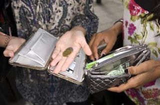 Teenage girls holding coins