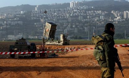 An Israeli soldier guards an Iron Dome rocket interceptor battery in Halfa, Jan. 28.