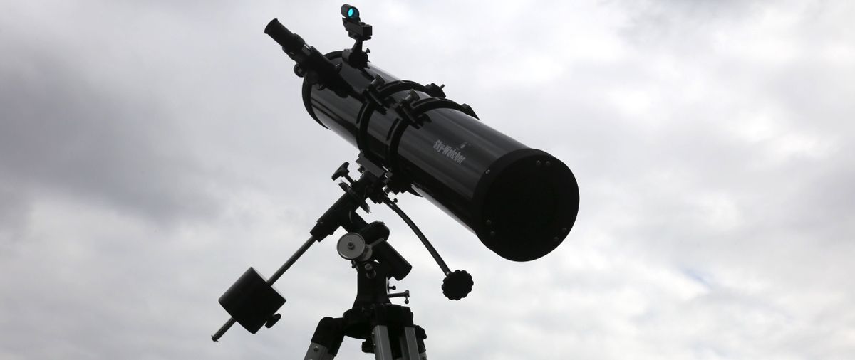 Sky-Watcher telescope set against a cloudy sky