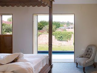 Four poster bed with view of nature from balcony