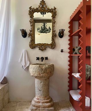 Mexican decor bathroom with red shelving and stone sink