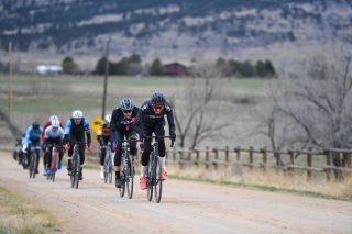 Men in the pro field fight in wind gusts of 25-35mph at 2024 Boulder Roubaix