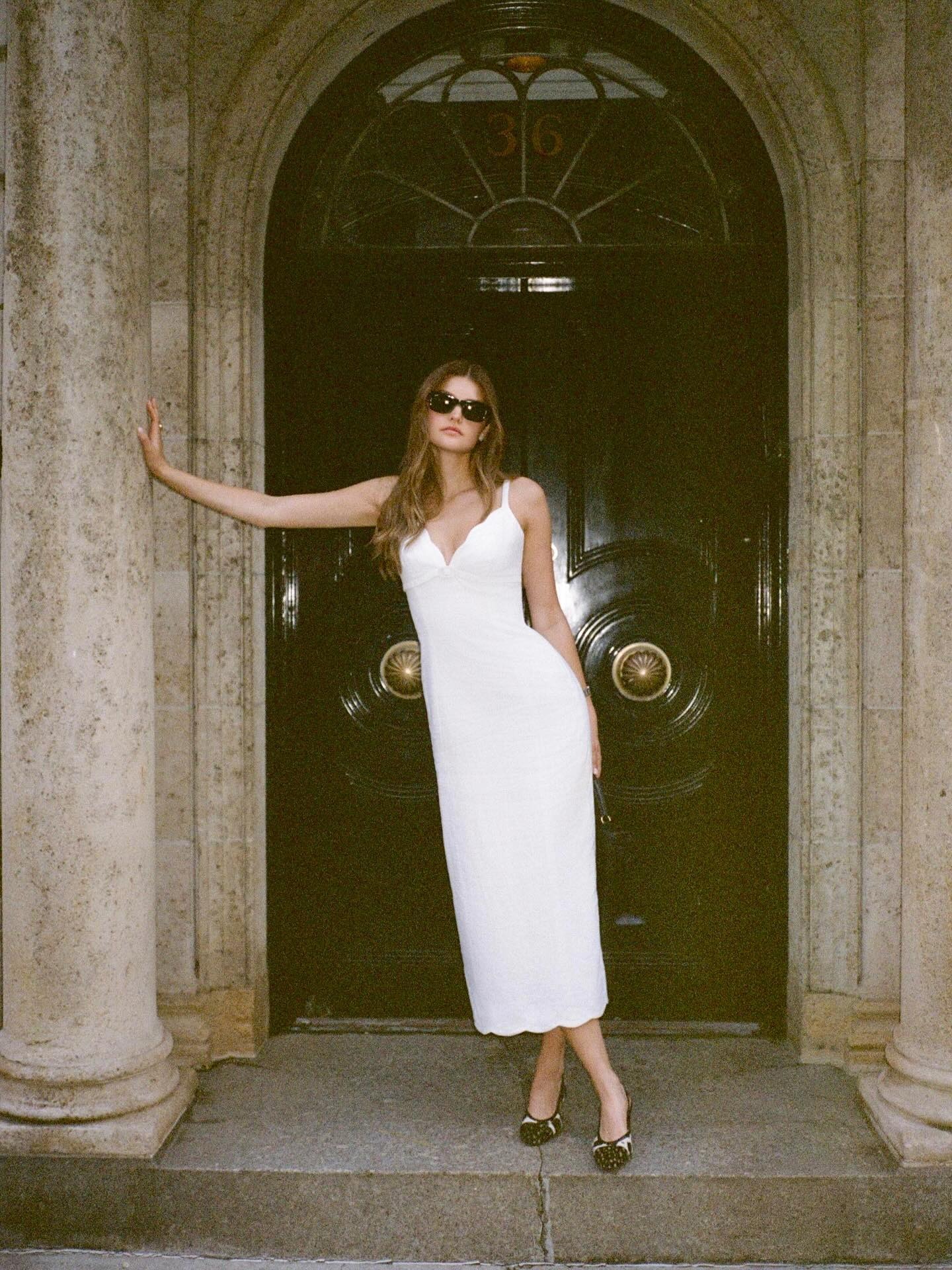 Woman wearing white elopement outfit.