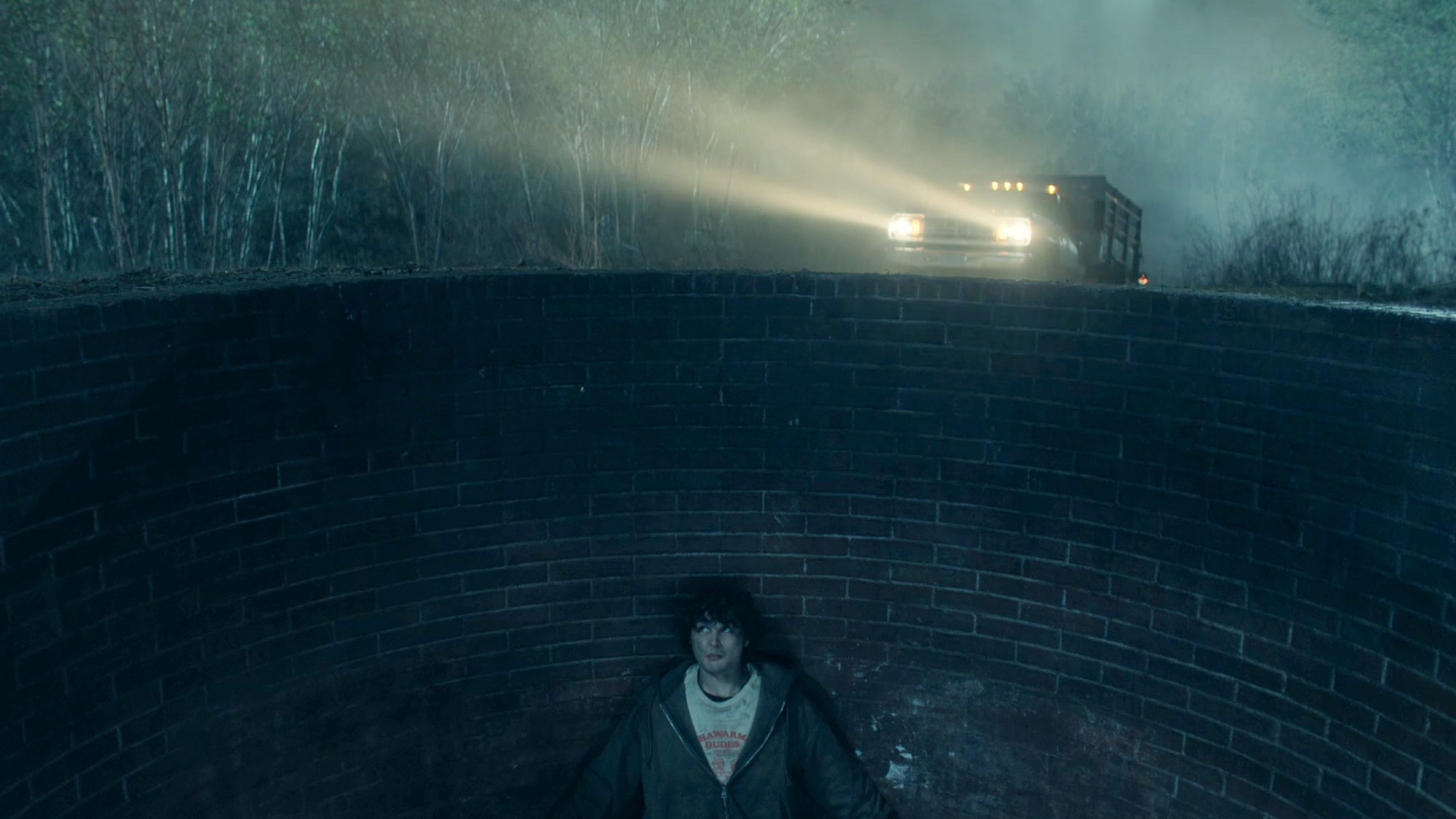 Keno hiding in a pit as a truck drives up to it in Neagley.
