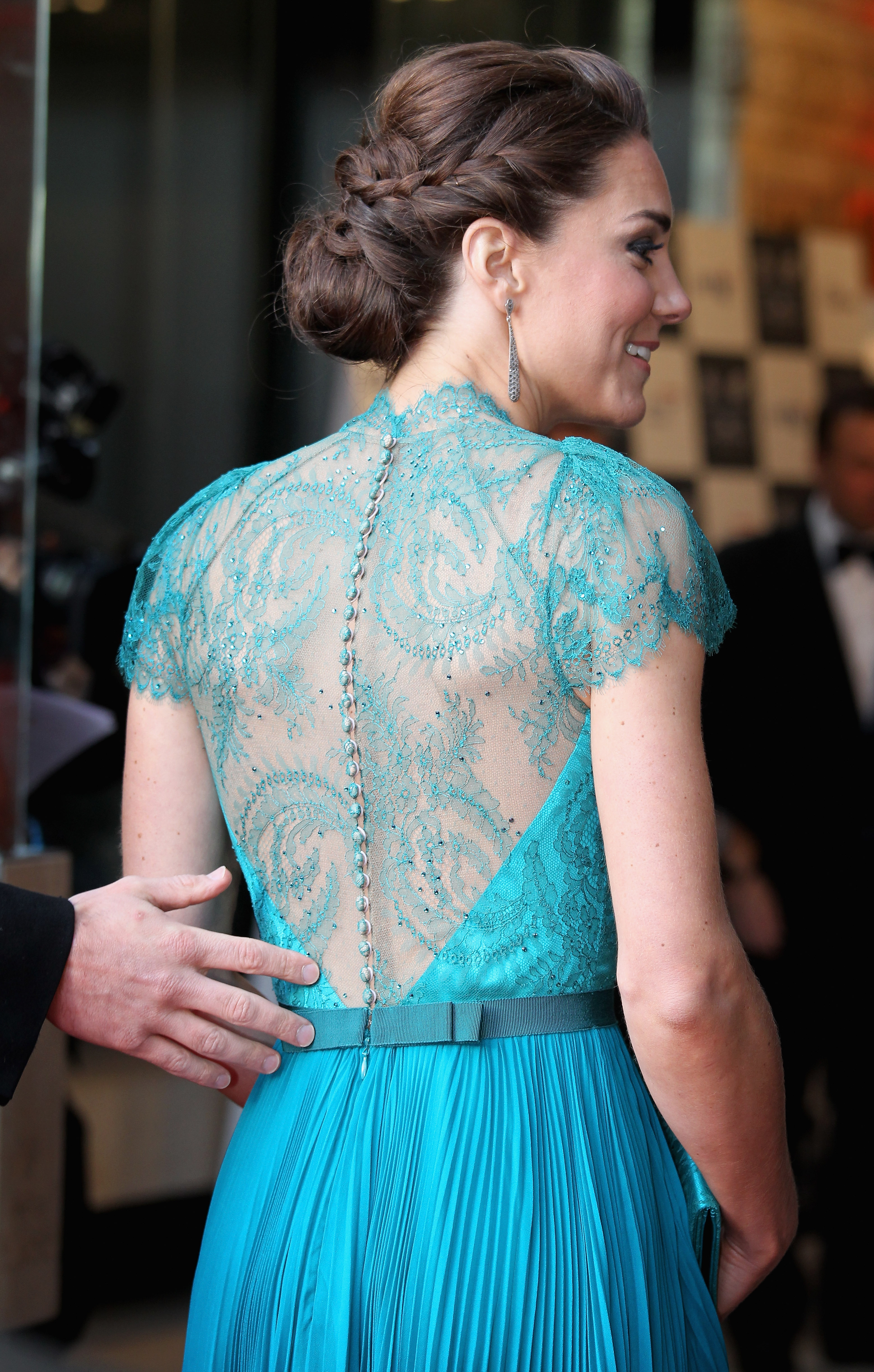 Kate Middleton's back, revealing a teal lace dress