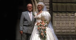 Oh, beloved Bet Lynch/Gilroy - committing crimes against fashion since 1966. If we didn't know any better, the ex-Rovers landlady could be hiding the wedding cake in those sleeves...