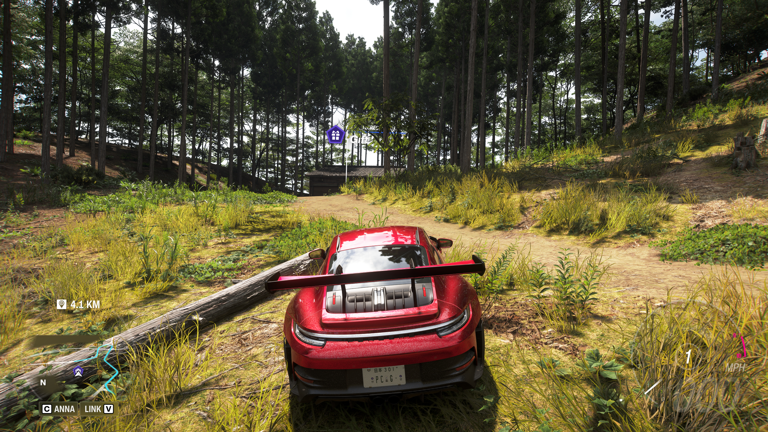 Forza Horizon 6 Barn Finds: A player parked on a dirt path ahead of an old barn in a forest.