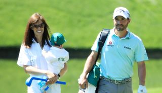 Kisner walks with his wife