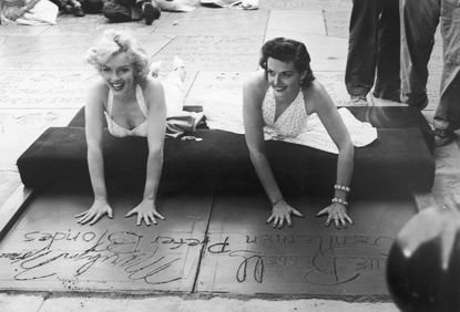 1953: Leaving her hand and footprints in cement