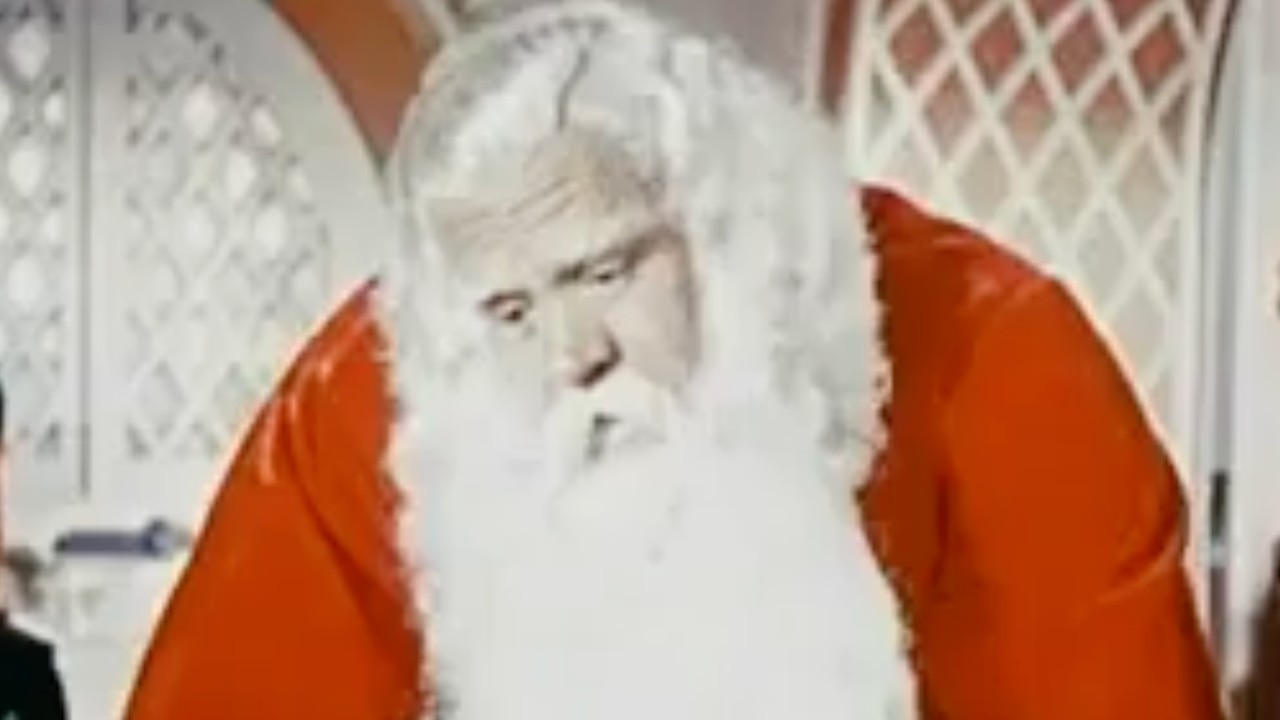 Santa Claus looking down on the children with worry.