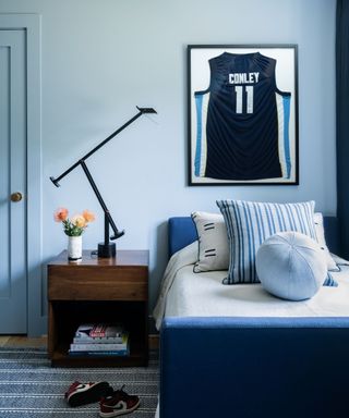 Blue bedroom, blue bed, wooden bedside table