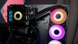 An Arctic Liquid Freezer III Pro liquid cooler set-up on a test bench with the RGB enabled.