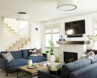 Living room with twin sofas, fireplace and TV