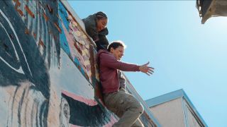 Tiffany Haddish dangling Eric Andre off a building in Bad Trip