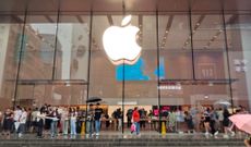 Customers brave the rain to inquire about exchanging their old iPhones for new ones at Apple's flagship Nanjing Road Pedestrian Street store in Shanghai, China, on September 10, 2024. 